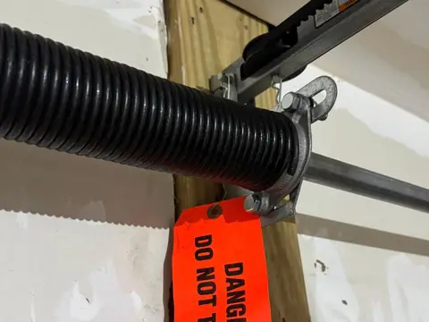 Garage door torsion spring tagged during a repair