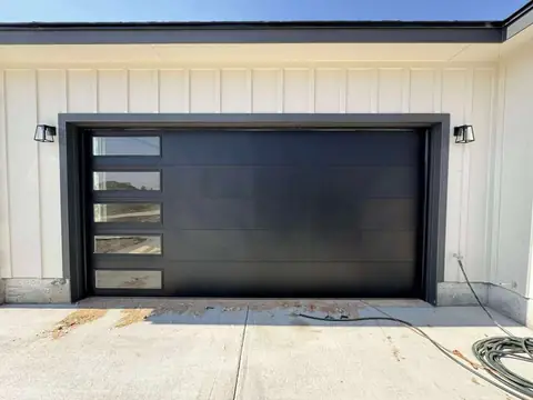 Modern black garage door with side windows