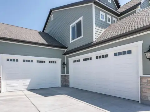 Two white carriage-style garage doors